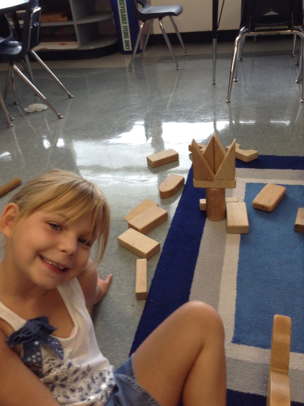 One of my favorite things is to see how kiddos' brains work while they are building.  For some reason when I look at blocks (including Legos), I see "square" things like houses, cars and buildings.  I love how others see more organic things in those blocks.  Kylie made a flower here. :)
