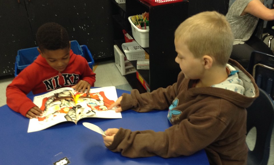 Even little Roadrunners can read together--C.J. and Landen are checking out a new book fair book--Bugs in My Hair!