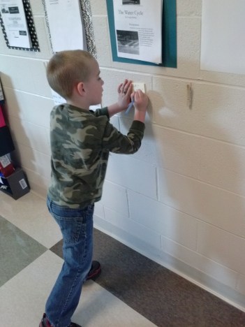 Peyton stops to write a note about a diorama he saw in the 5th grade hall.